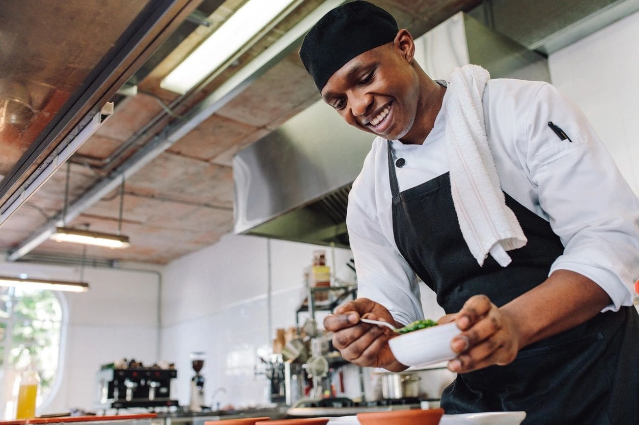 A chef is preparing food in the kitchen.