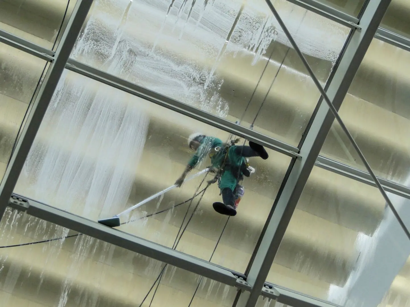 A person is cleaning the windows of a building.