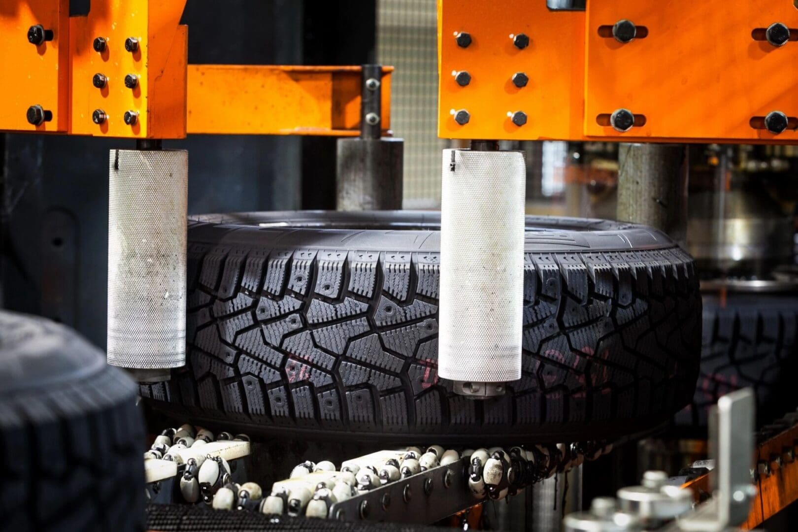 A tire being made on a machine in a factory.